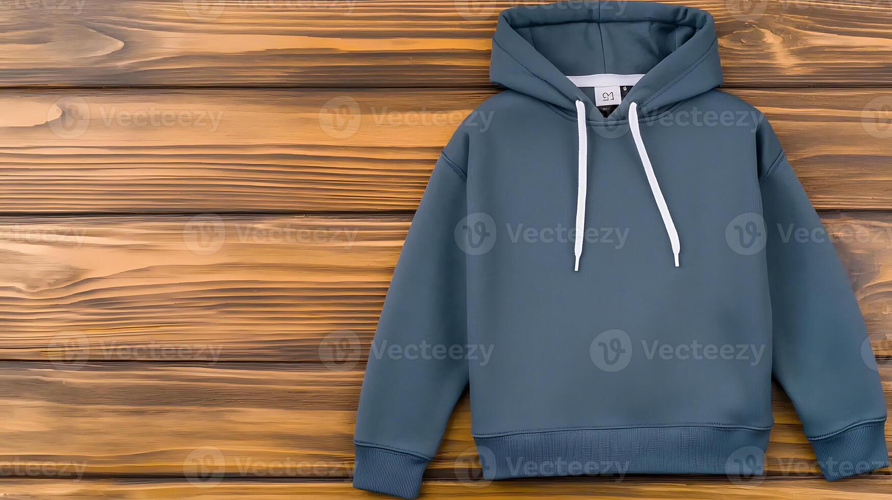 Stylish blue hoodie displayed against a rustic wooden background, ideal for fashion promotions photo