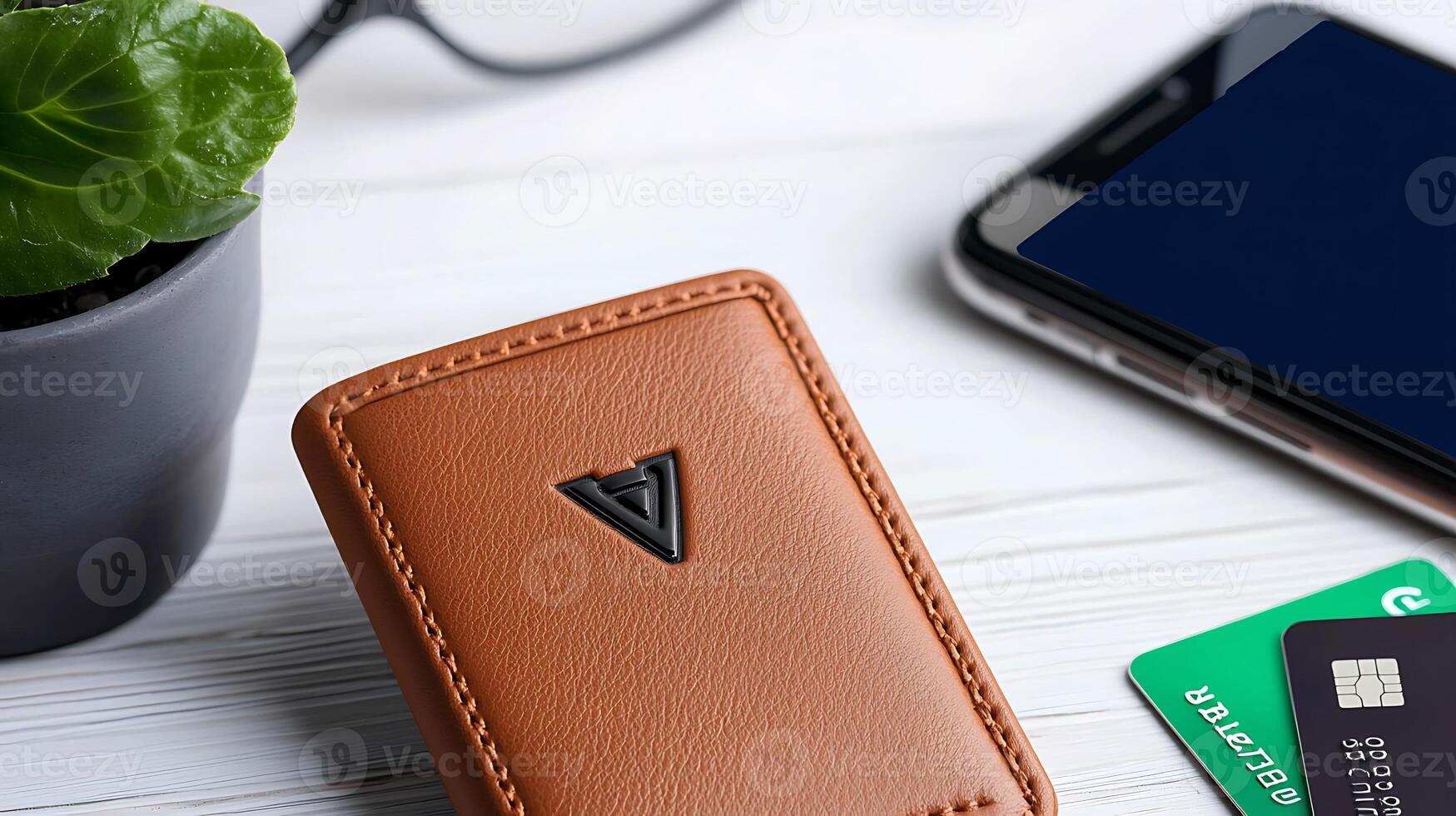 Stylish brown wallet placed on a wooden table with a smartphone and credit cards nearby photo