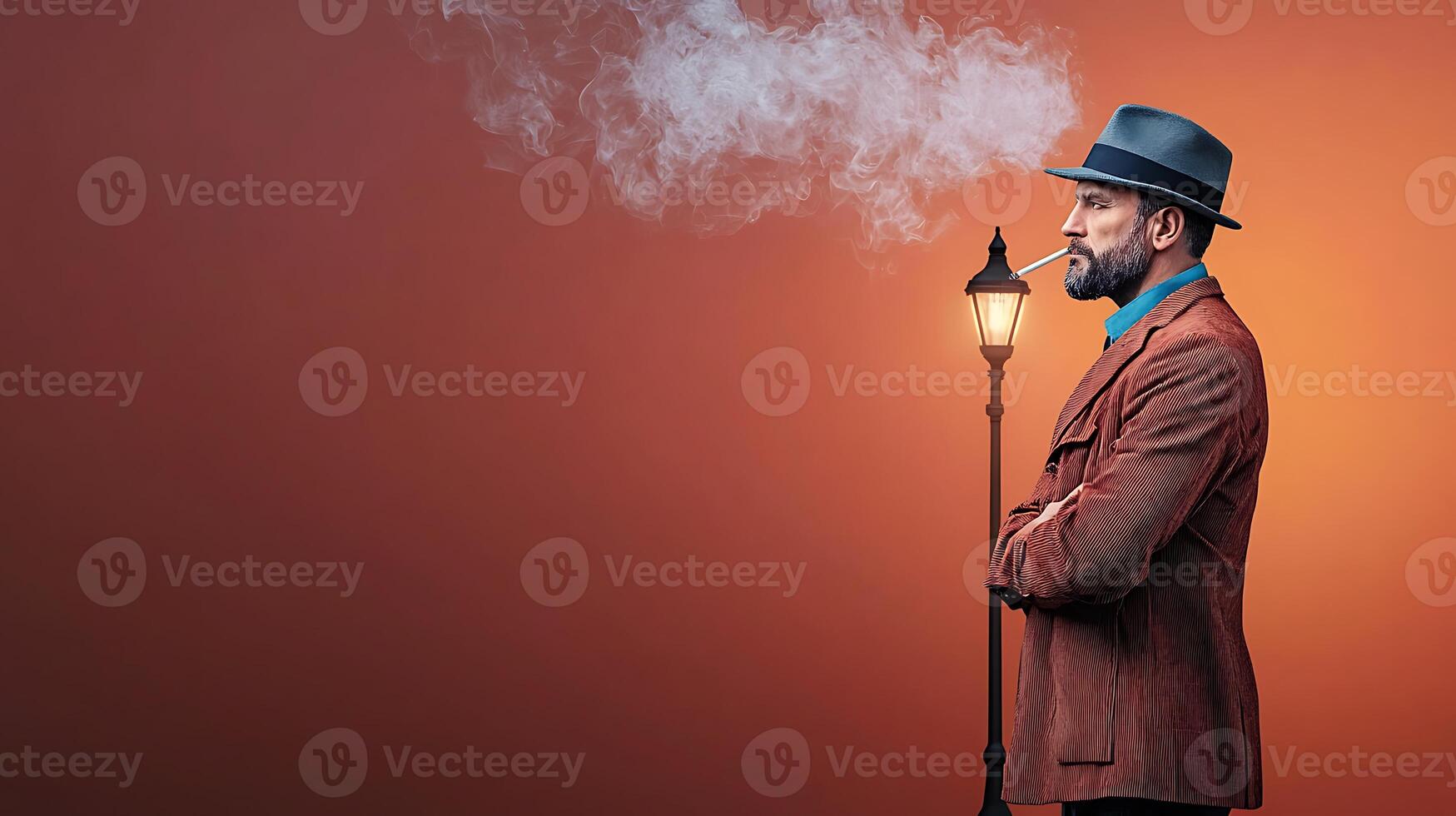 Stylish man in a brown suit and hat, smoking by a lamp post against a warm background photo