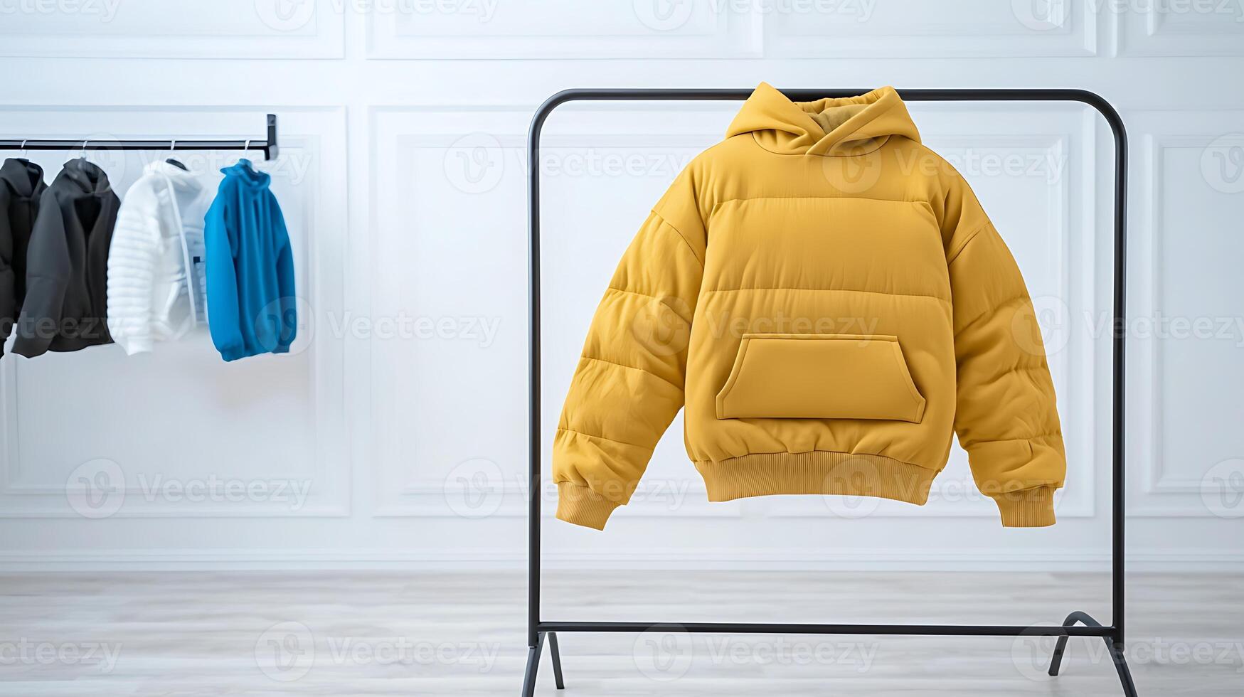 Stylish yellow puffer jacket displayed on a rack with other jackets in a modern showroom photo