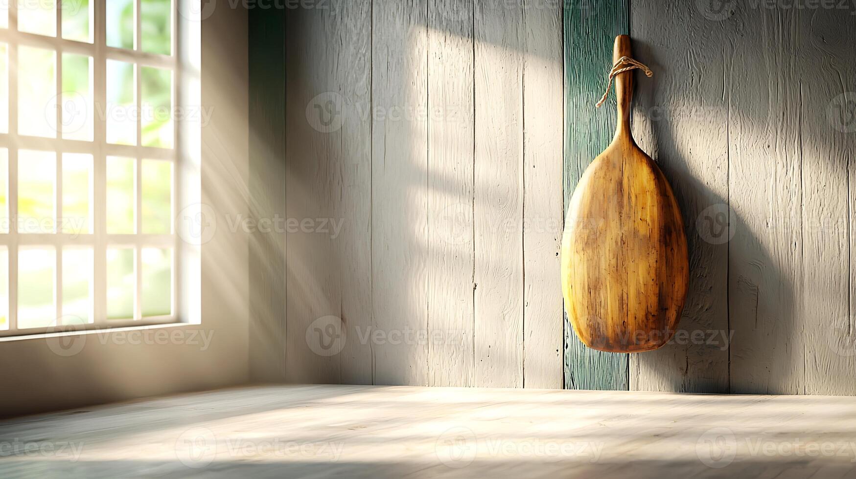 Sunlit wooden paddle hanging on a wall in a serene kitchen with natural light streaming in photo