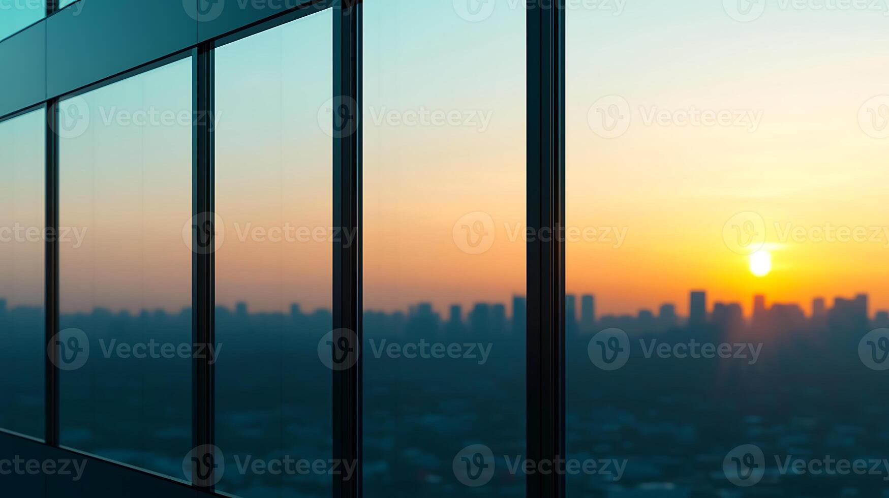 Sunset view from a modern building's glass windows overlooking a city skyline at dusk photo