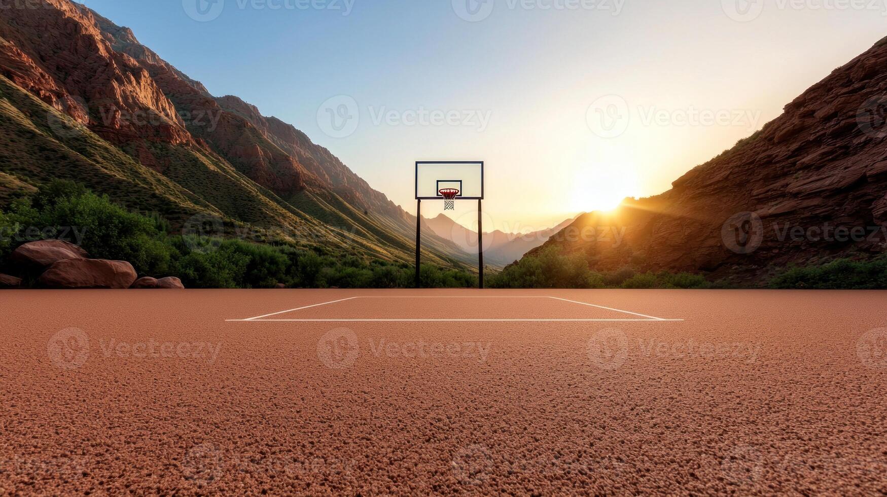 Sunset over a basketball court surrounded by mountains, capturing a serene and active atmosphere photo