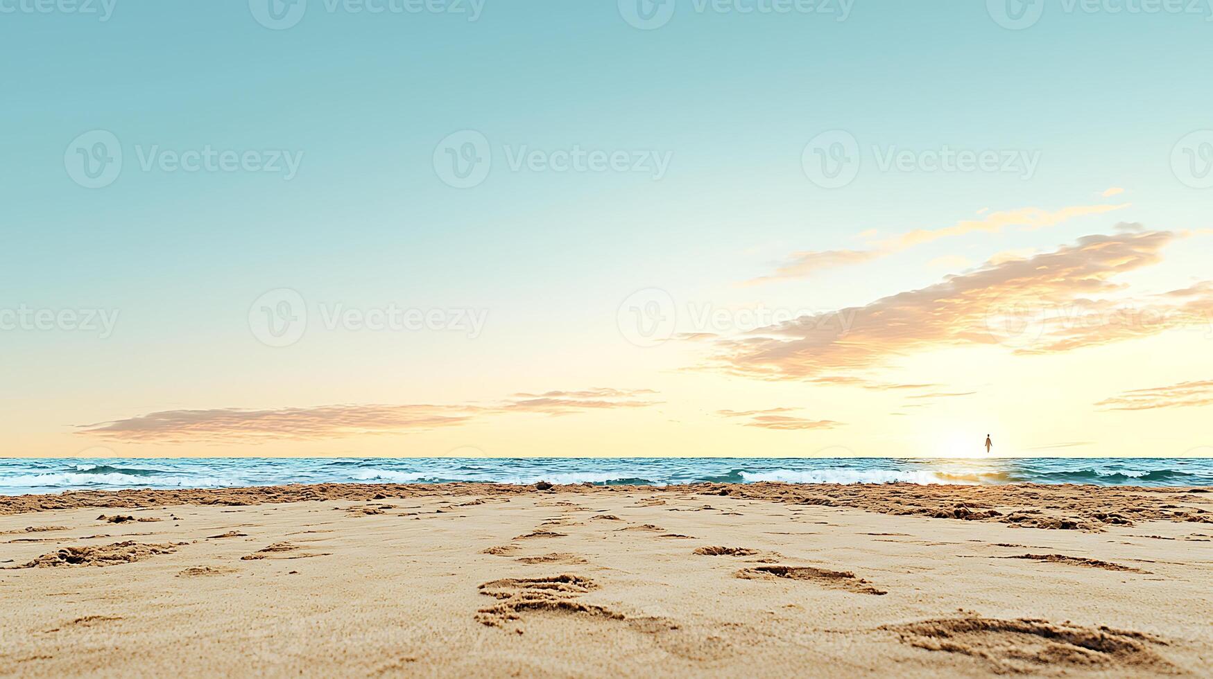 Tranquil beach scene at sunset with footprints in the sand and gentle waves lapping the shore photo