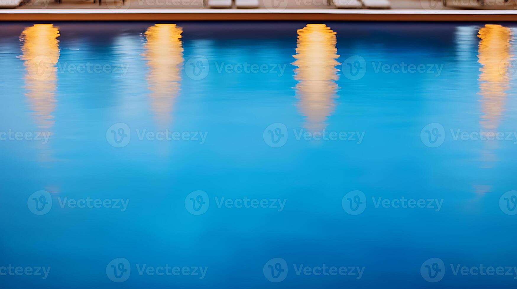 Tranquil evening at a pool with glowing lights reflecting on the serene water surface photo