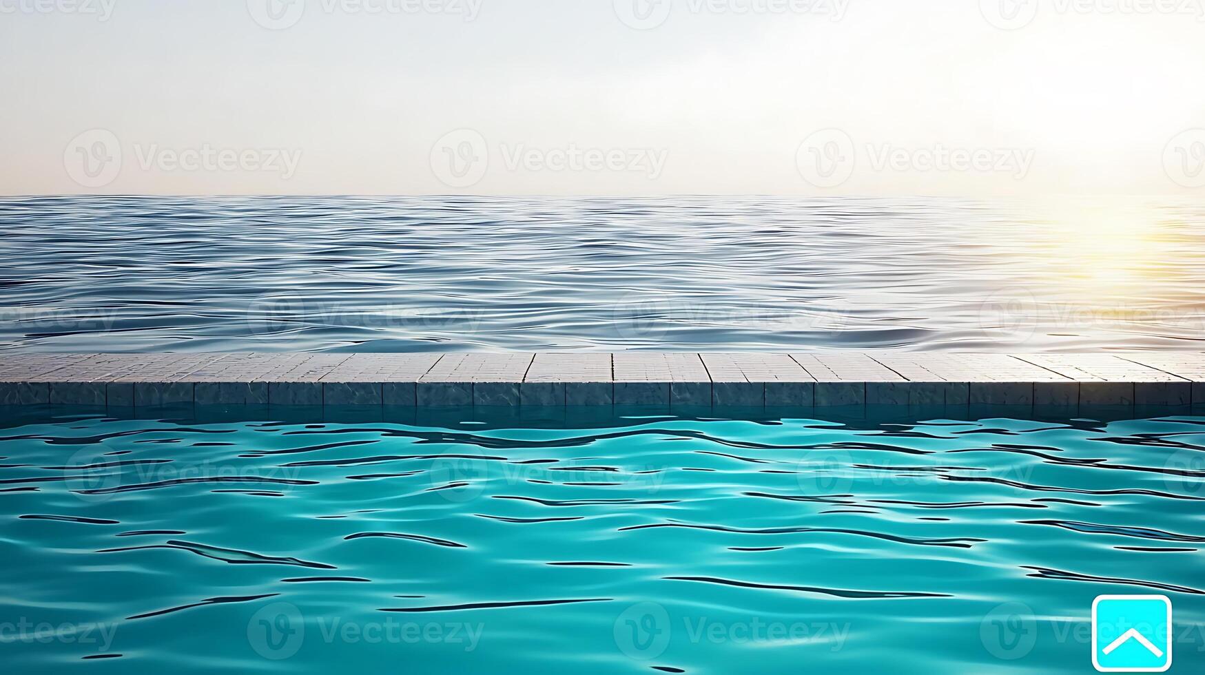 Tranquil poolside view at sunset, with calm waters reflecting the warm sky and horizon photo