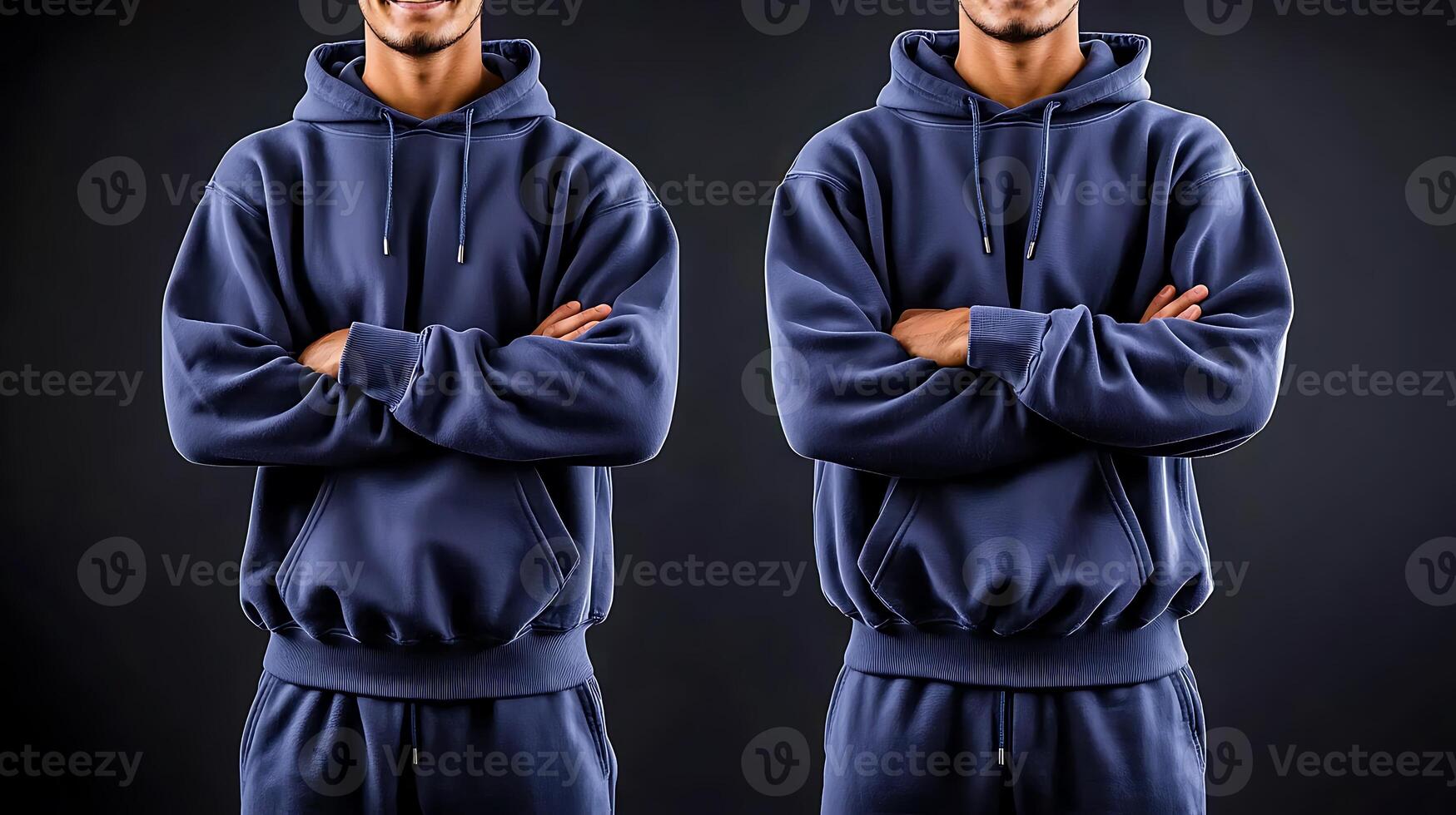 Two men in matching navy hoodies standing confidently with arms crossed against a dark backdrop photo