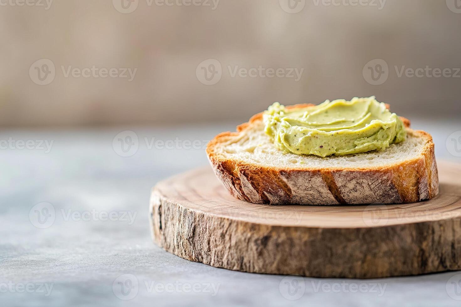 Warm, crusty bread is generously spread with pistachio butter, showcasing a delightful contrast of textures. This rustic presentation captures the essence of simple, comforting food photo