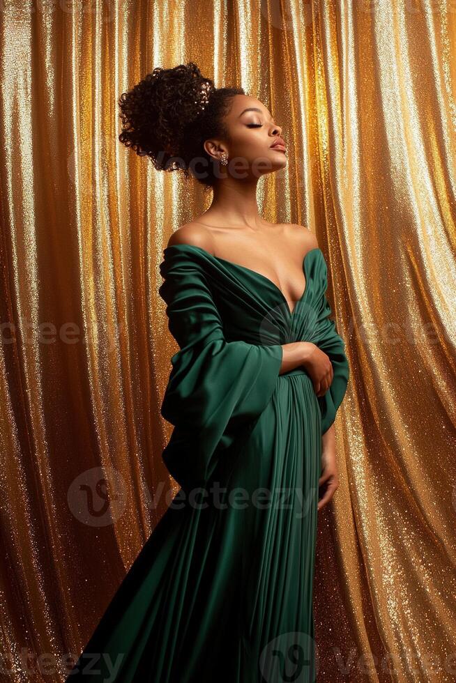 A woman stands gracefully in an emerald green gown, illuminated by soft lighting. The shimmering gold curtains enhance the elegance of the scene, creating a luxurious atmosphere photo