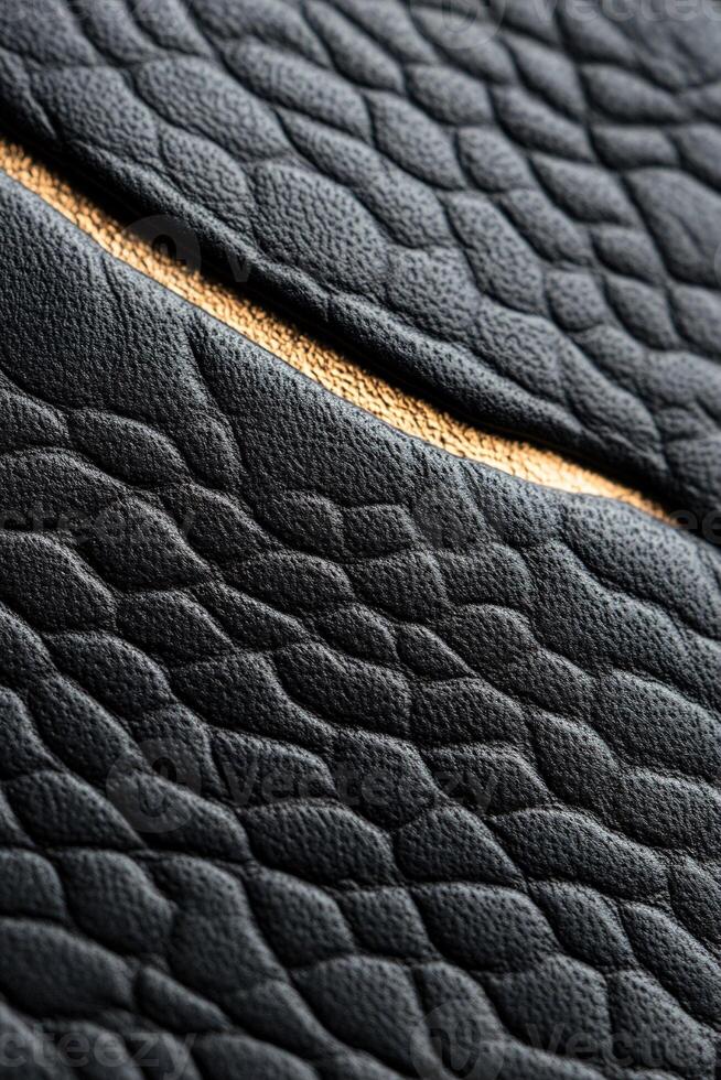 Rich black leather showcases intricate embossed patterns and subtle gold foil accents, creating an elegant surface ideal for premium text placement and upscale design elements photo