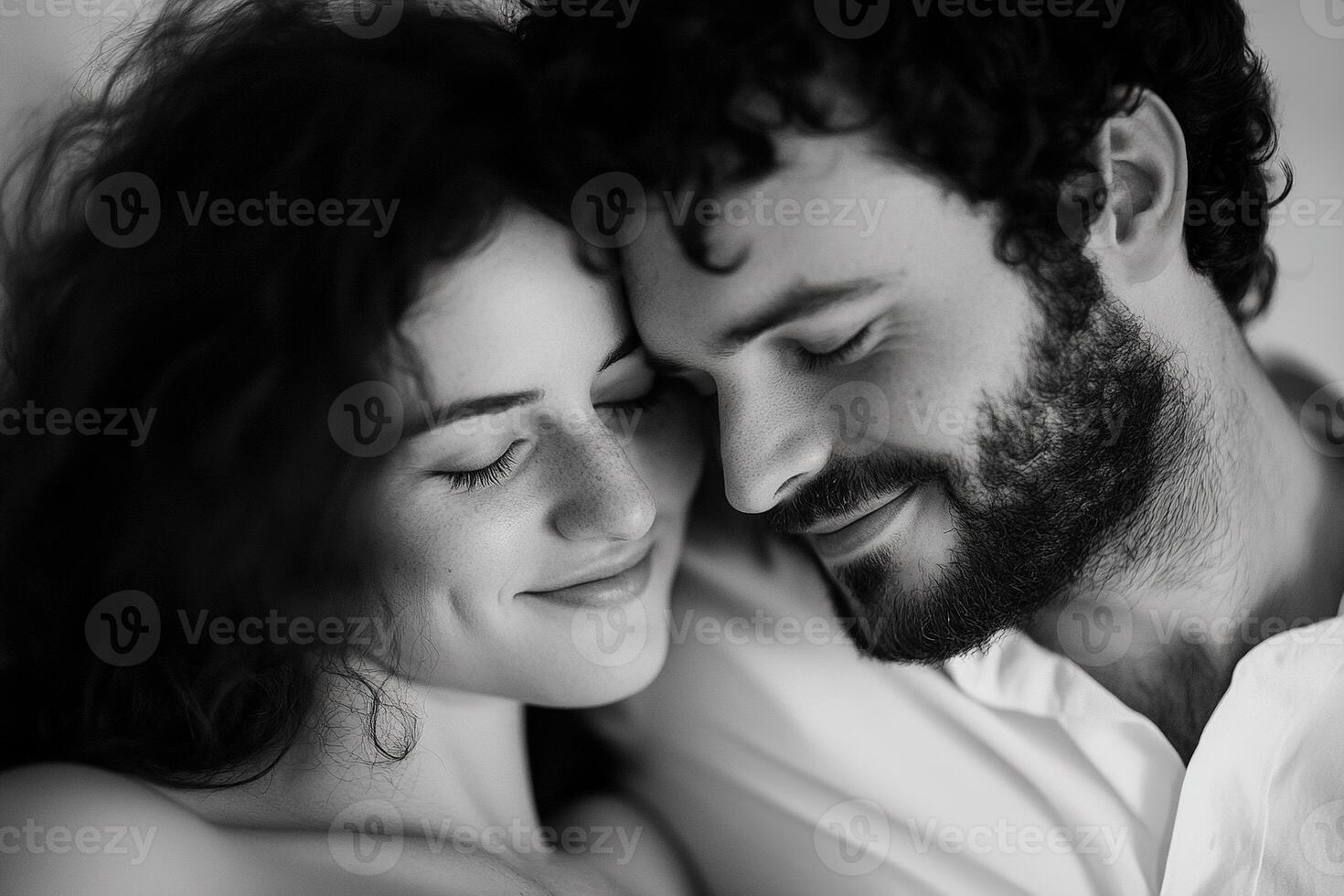 In a tender moment, a father-to-be leans his head on the belly of the mother, sharing laughter as their baby kicks softly. The blurred background enhances the feeling of intimacy photo
