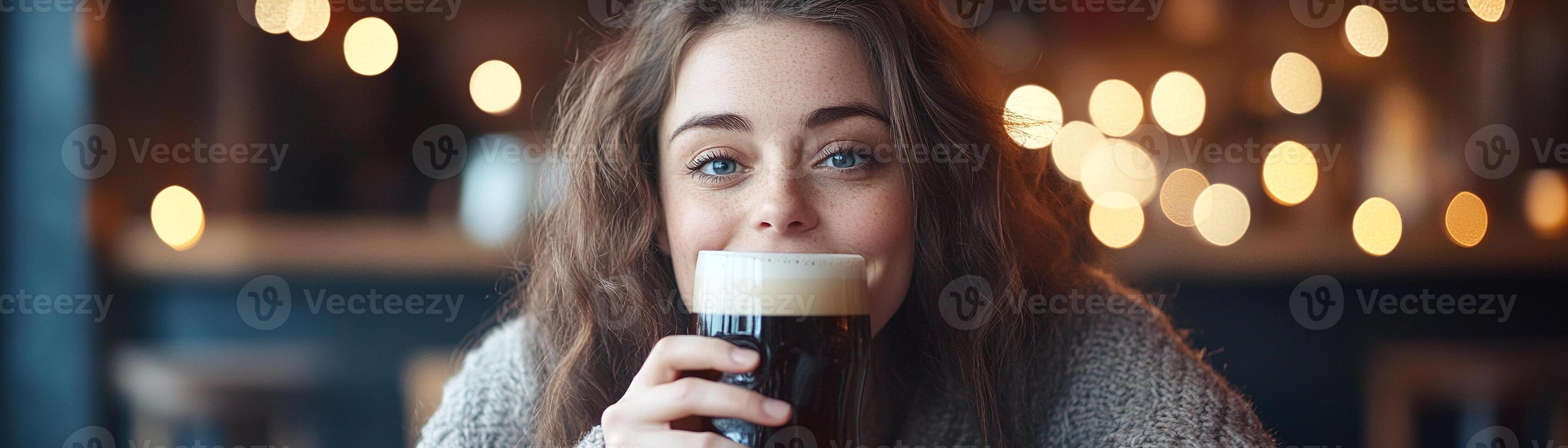 A woman sits comfortably in a traditional Irish pub, sipping a pint of rich stout beer. The warm glow from surrounding lights creates a cozy atmosphere, inviting relaxation and enjoyment photo