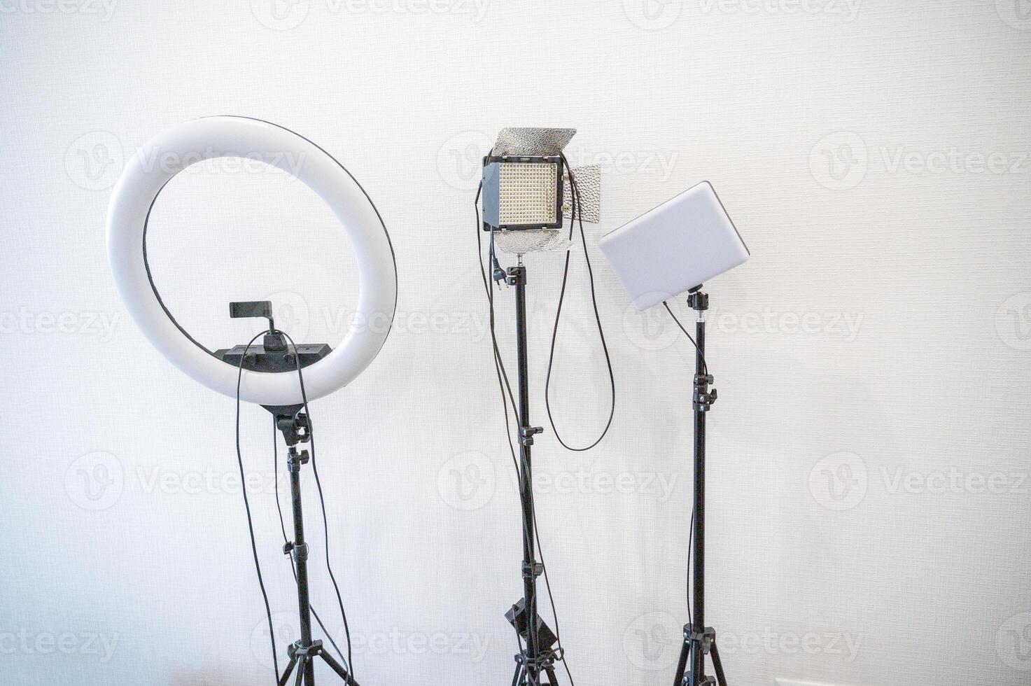 professional light sources against a white wall. three different sources for photo and shooting. the shape of the light sources is different. ring lamp, rectangular with and without curtains