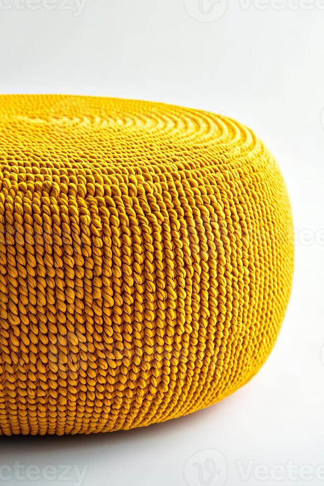 Bright yellow round woven pouf, perfect for outdoor or indoor decor. Its unique texture adds vibrant touch to any space, creating cheerful atmosphere photo