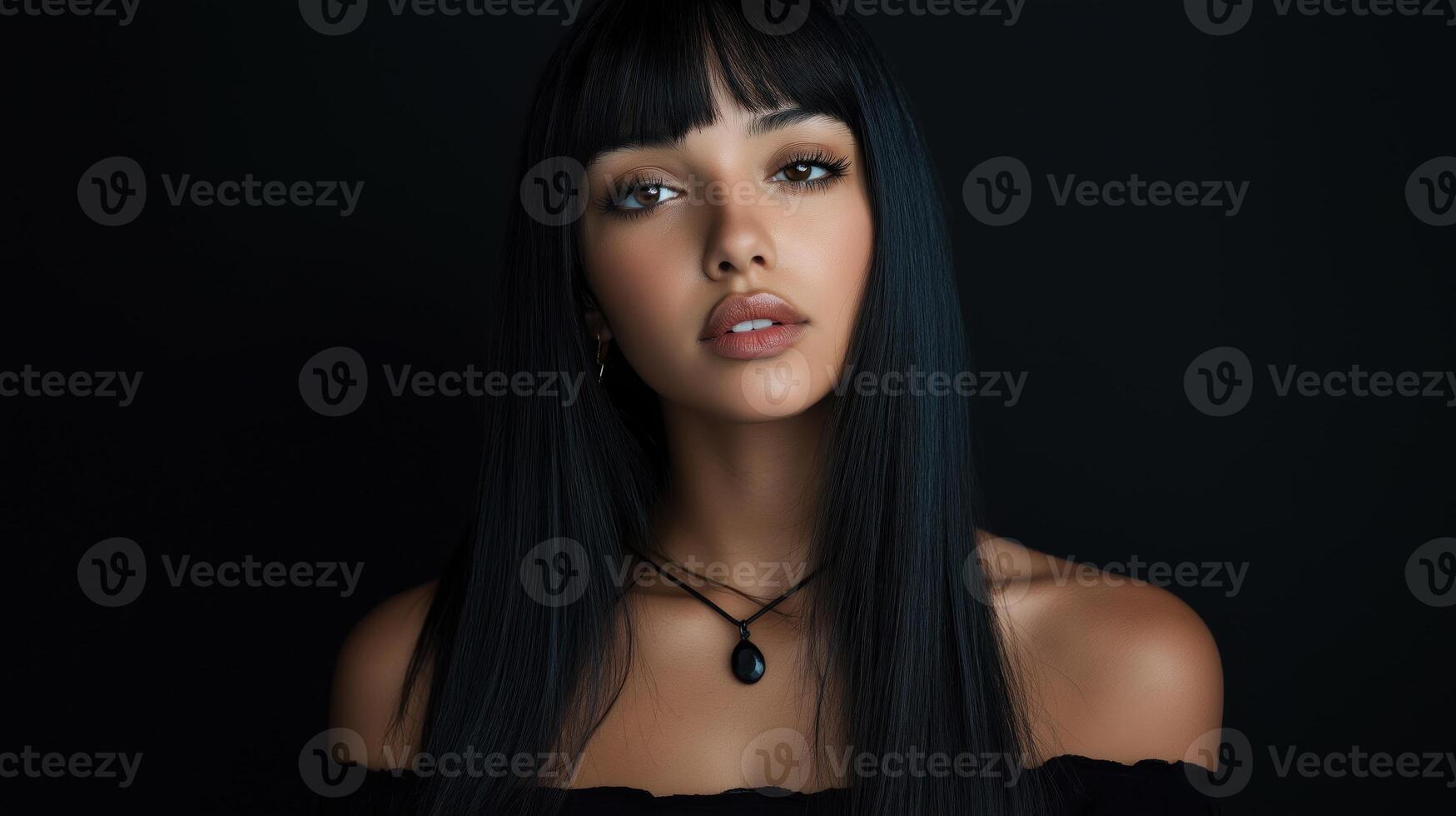 portrait of a young woman with long, straight black hair. She has a serious expression on her face and is looking directly at the camera. photo
