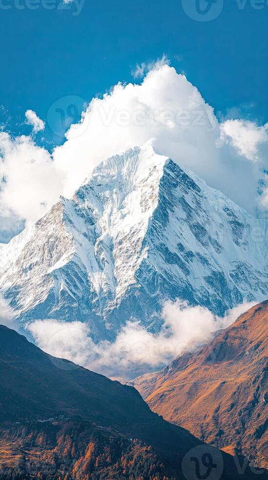 A Towering Peak Adorned with Snow Under a Dramatic Sky photo
