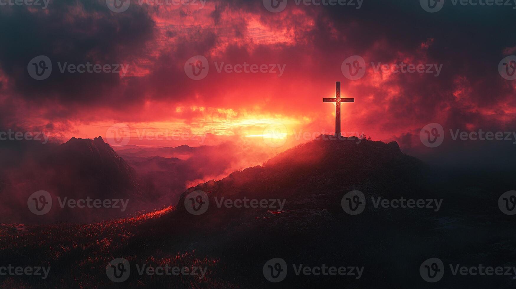 christian cross standing on mountain peak at sunset with dramatic sky photo
