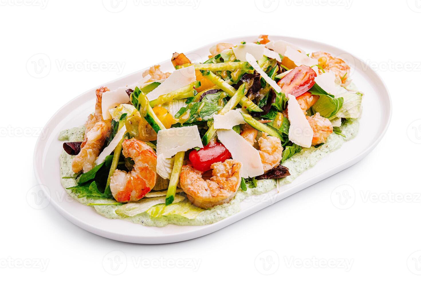 Refreshing shrimp salad topped with fresh vegetables and shaved cheese served on a white plate photo