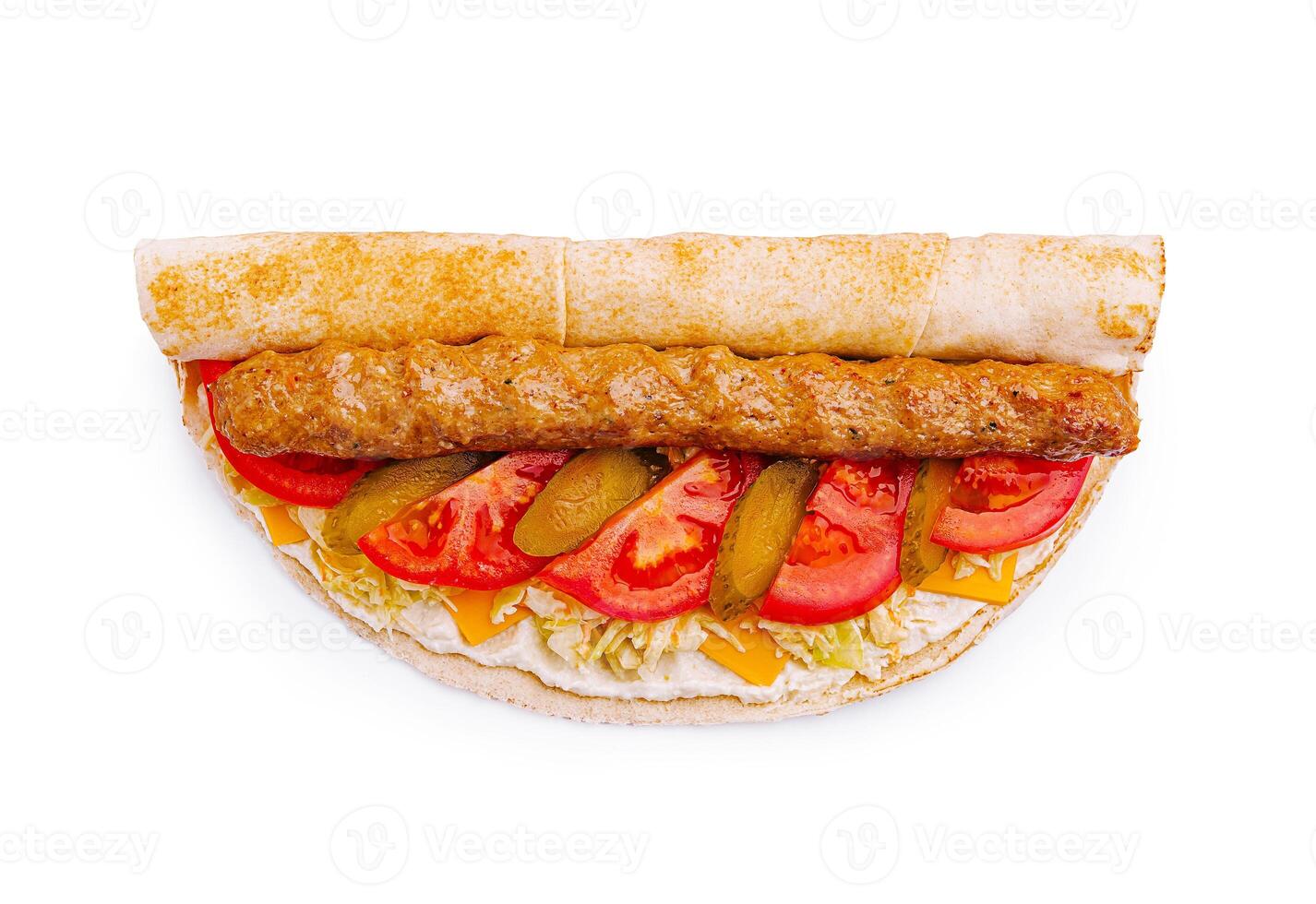 Savory wrap filled with grilled meat, fresh vegetables, and cheese served on a flatbread photo