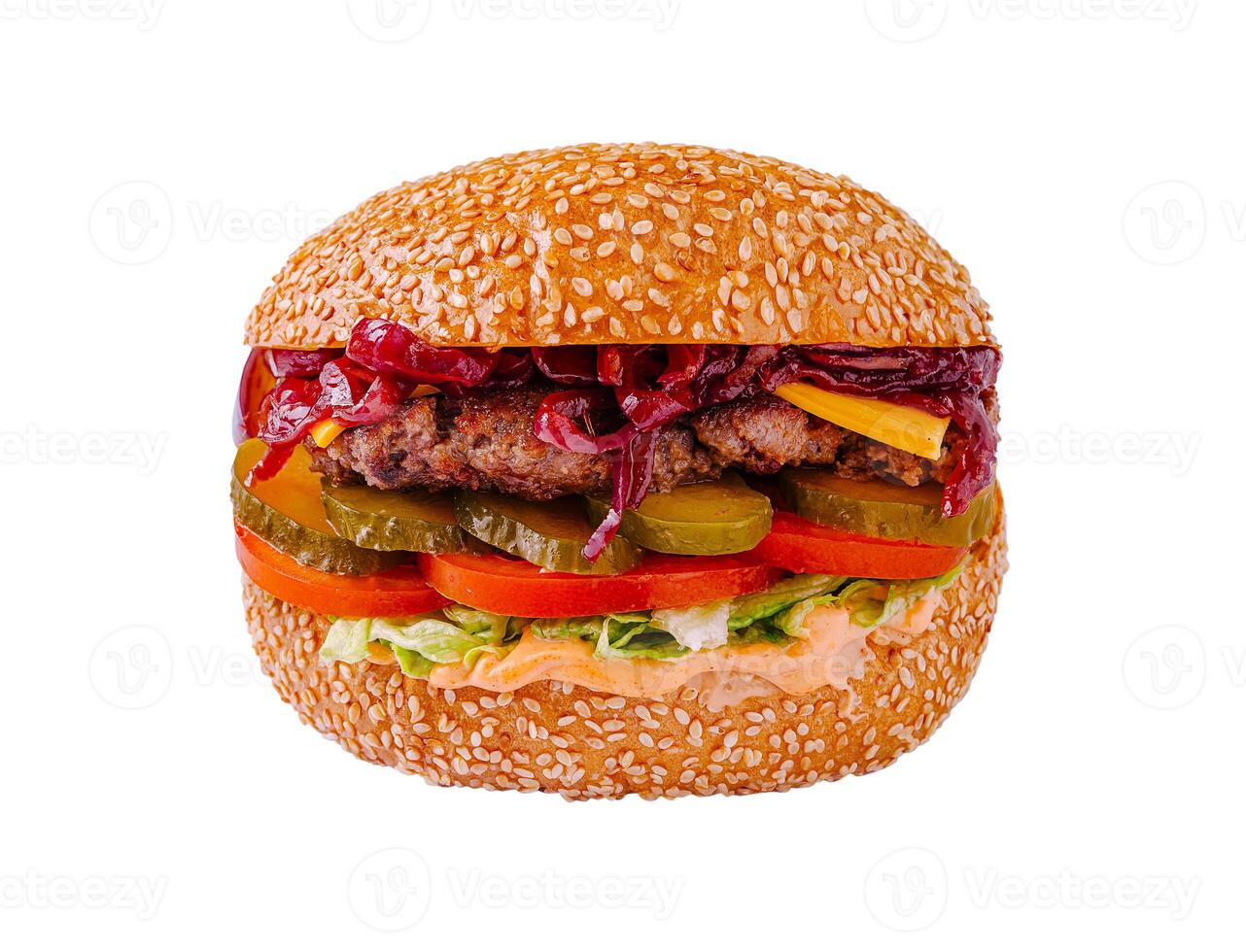 Juicy grilled burger loaded with fresh vegetables and flavorful sauces in a sesame seed bun photo