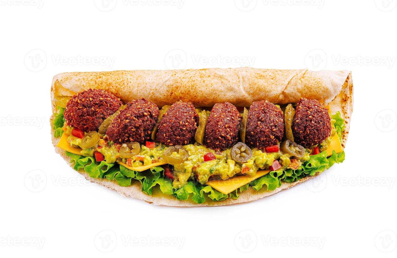 Tasty falafel wrap filled with fresh vegetables and creamy guacamole ready to enjoy for lunch photo