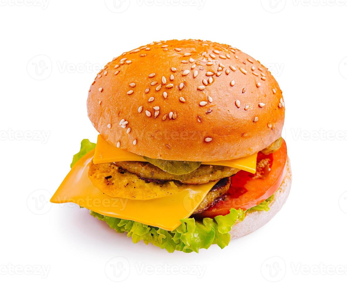 Delicious cheeseburger with lettuce, tomato, pickles, and sesame seed bun ready to be enjoyed photo