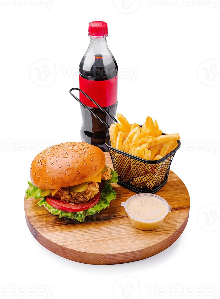 Tasty burger with fries and soda prepared on a wooden platter ready for enjoyment at a casual dining experience photo