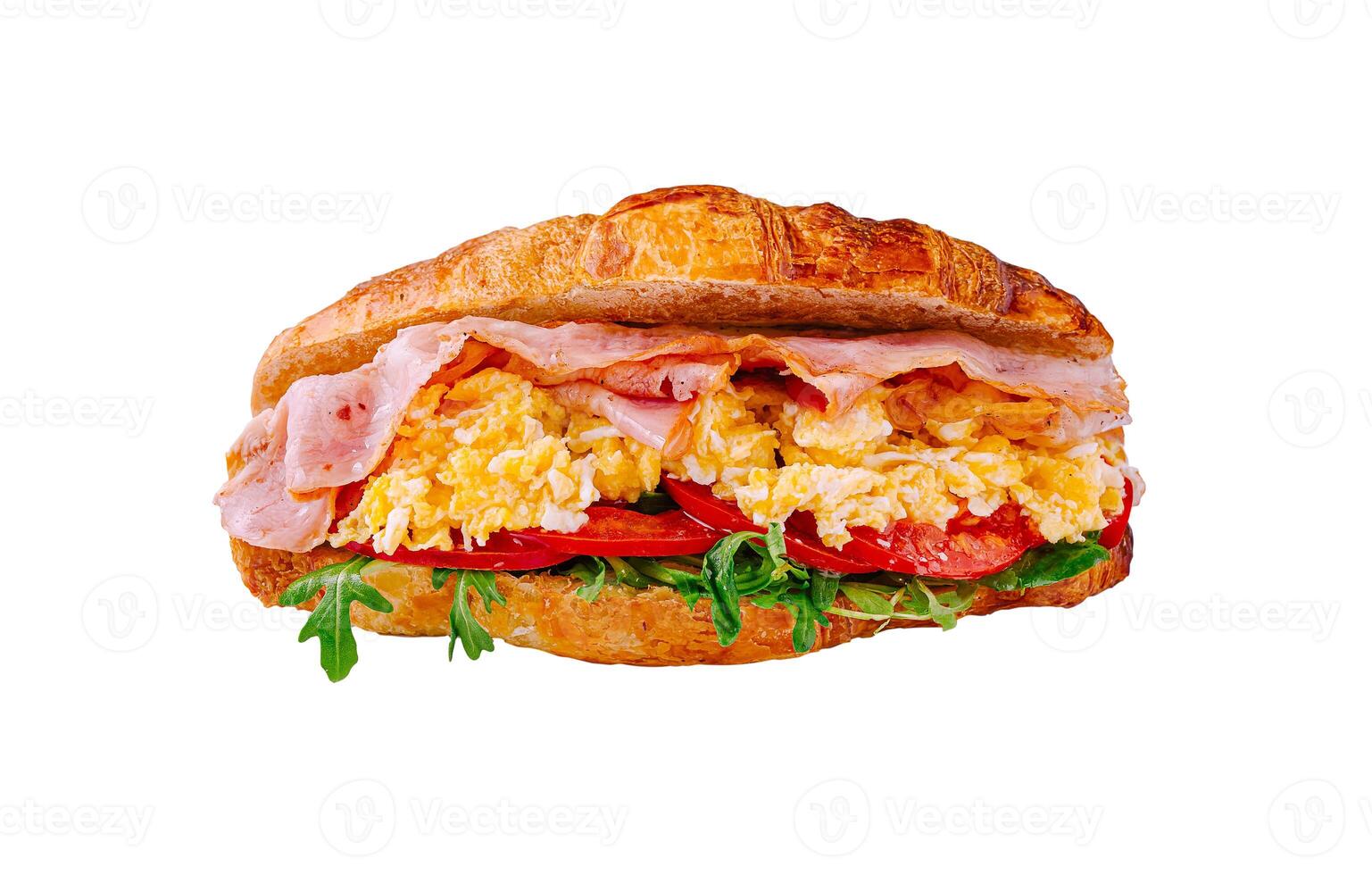 Delicious croissant sandwich filled with ham, scrambled eggs, and fresh vegetables made for a satisfying breakfast photo