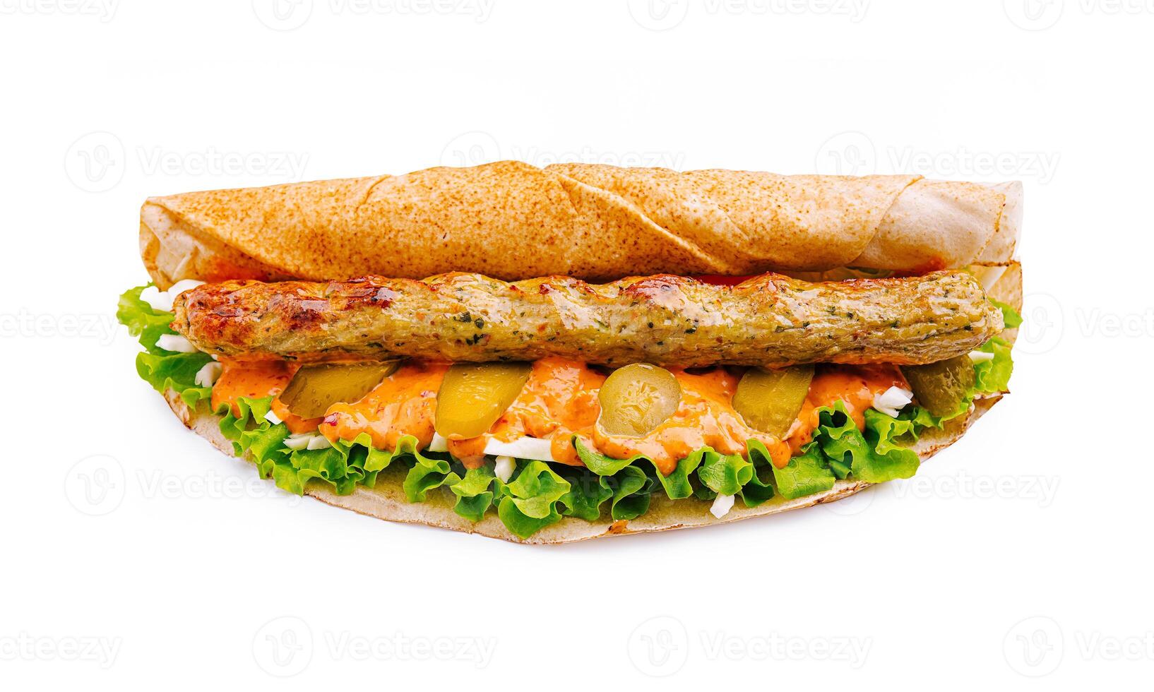 Savory grilled kebab sandwich with fresh vegetables served on a warm pita bread for a delicious meal experience photo