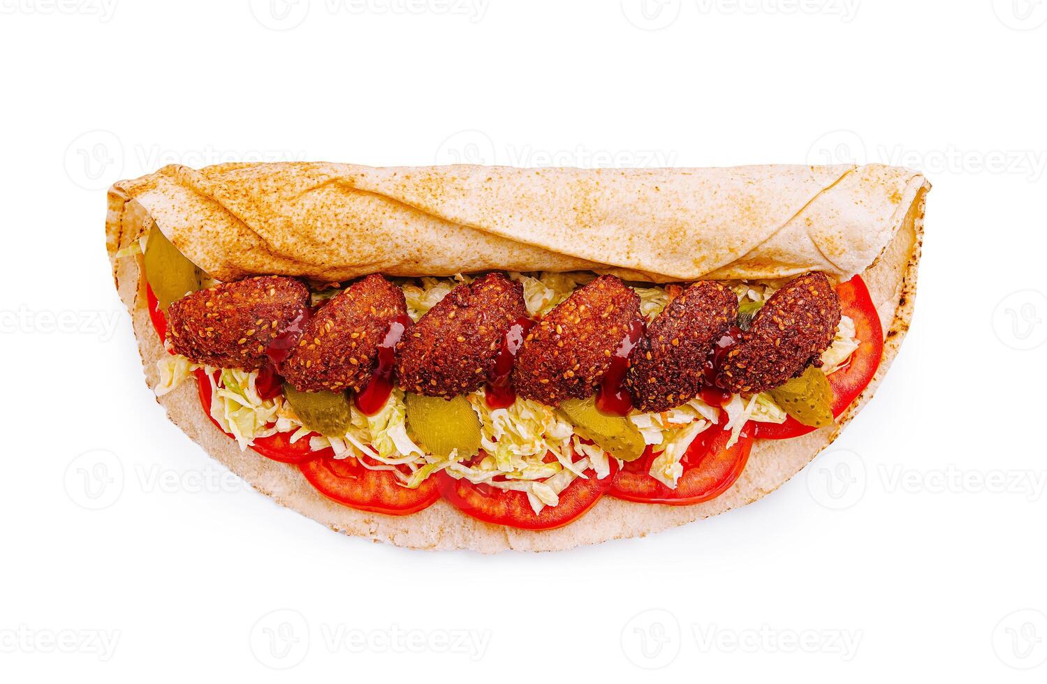 Delicious falafel wrap filled with fresh tomatoes, lettuce, and pickles ready to enjoy on a sunny day photo