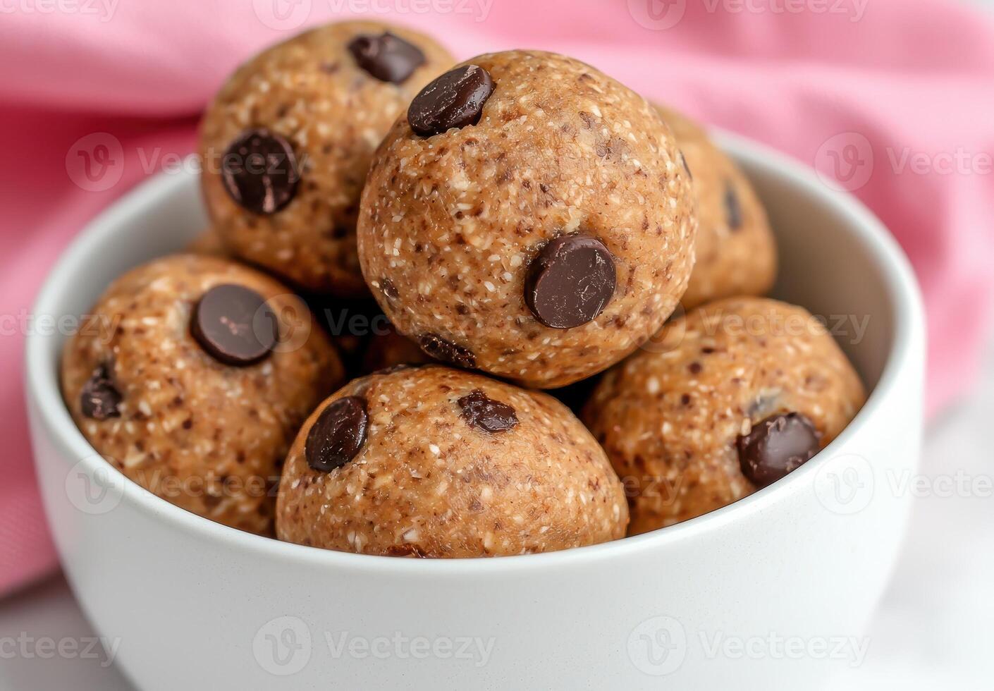 A bowl full of delicious chocolate chip cookie dough protein balls photo