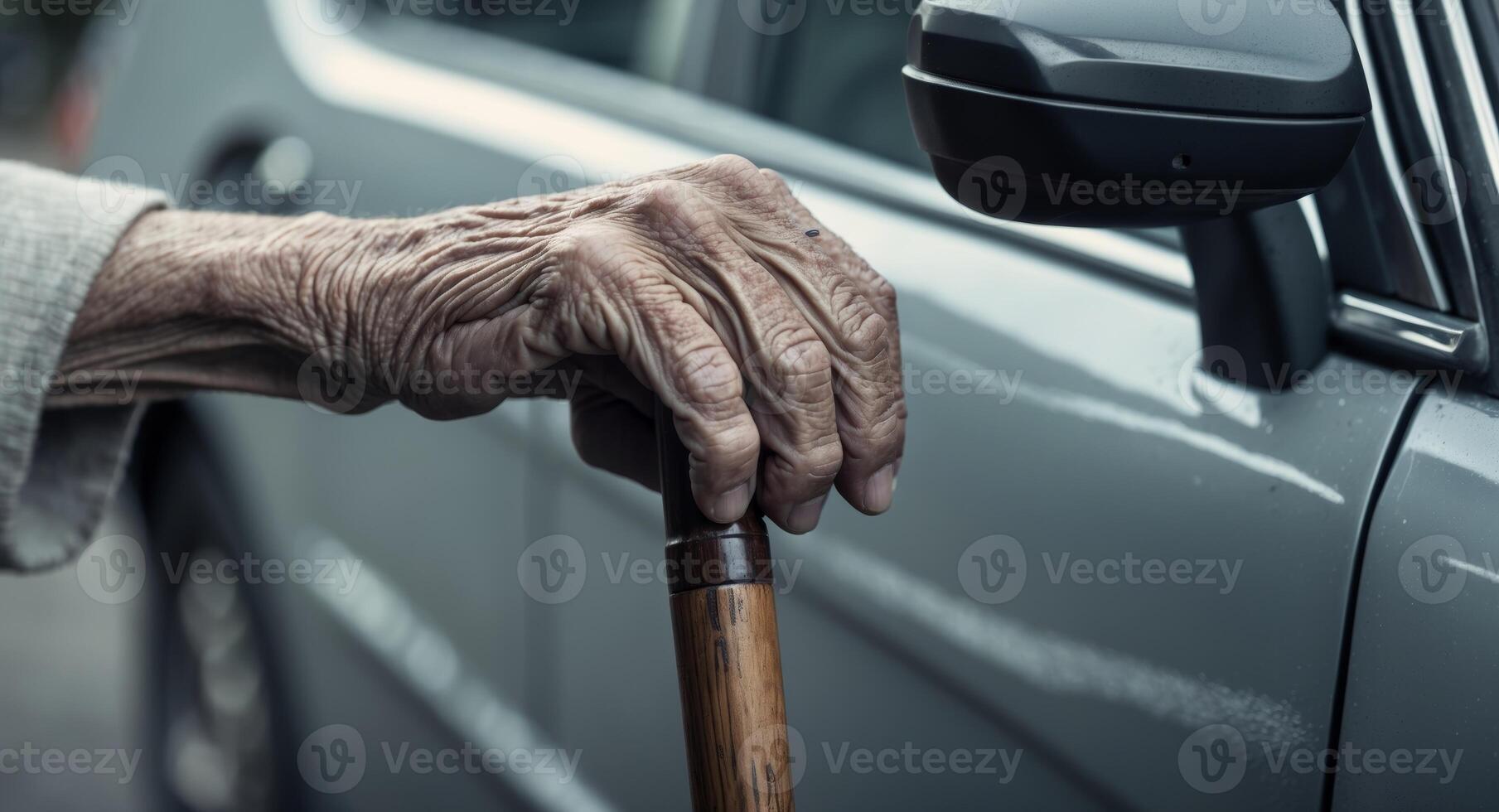 Elderly hand grips cane near car door determination shines in tight focus. photo