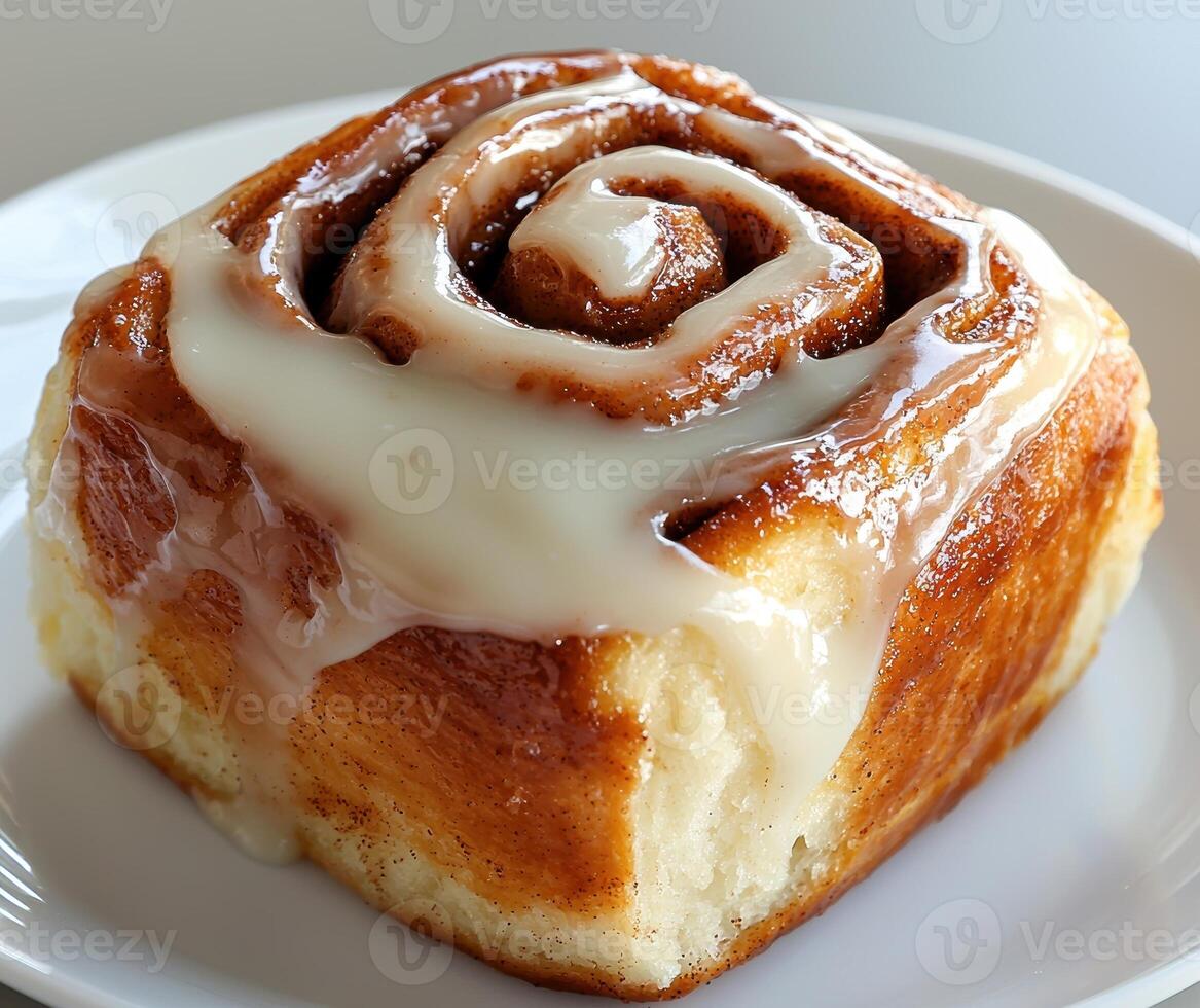Delicious cinnamon roll with sweet icing on a white plate photo