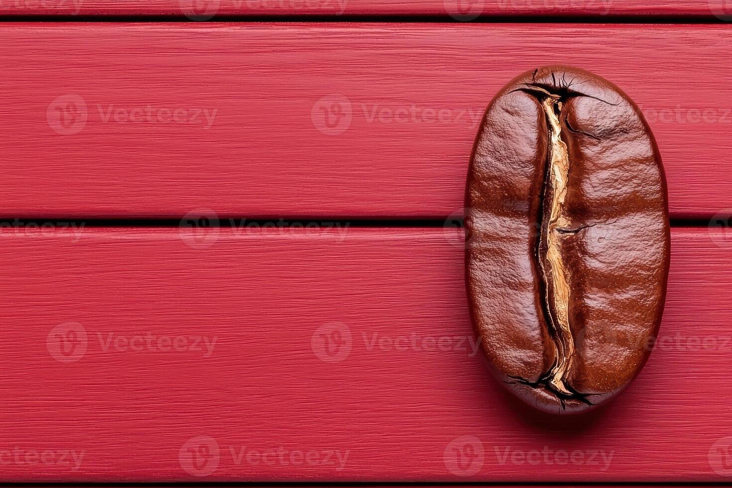 A close up of a single coffee bean on a red wooden surface photo