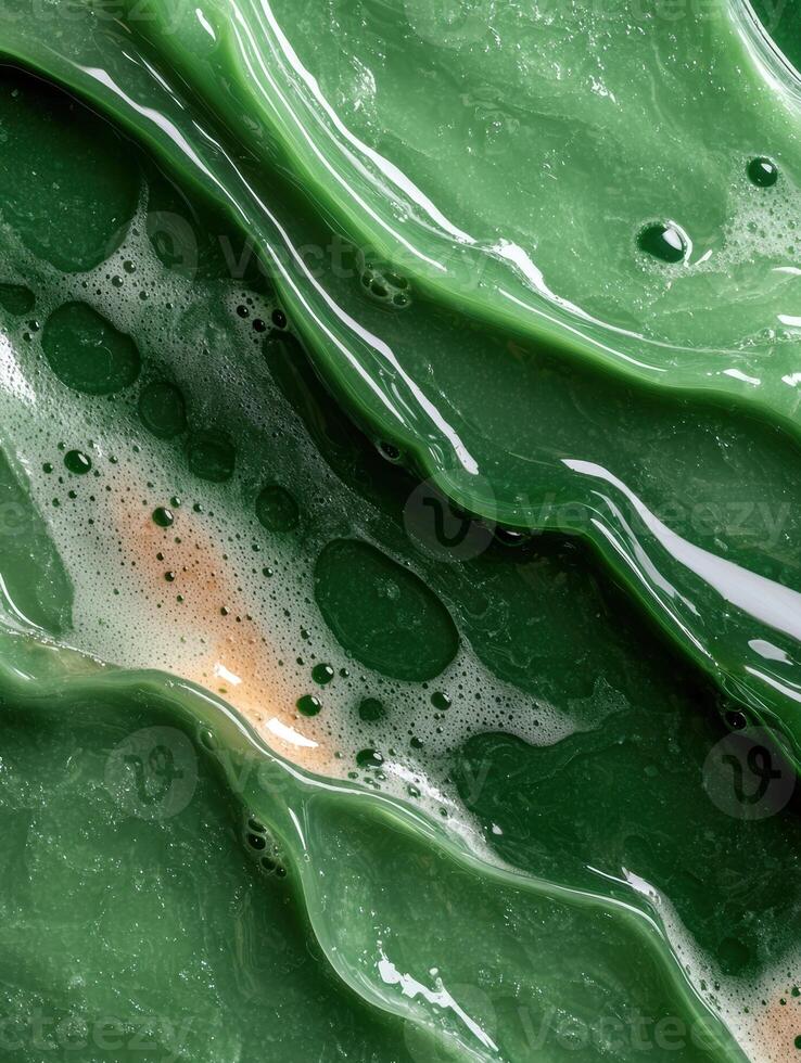 Abstract green liquid with bubbles and reflections, creating a textured background photo