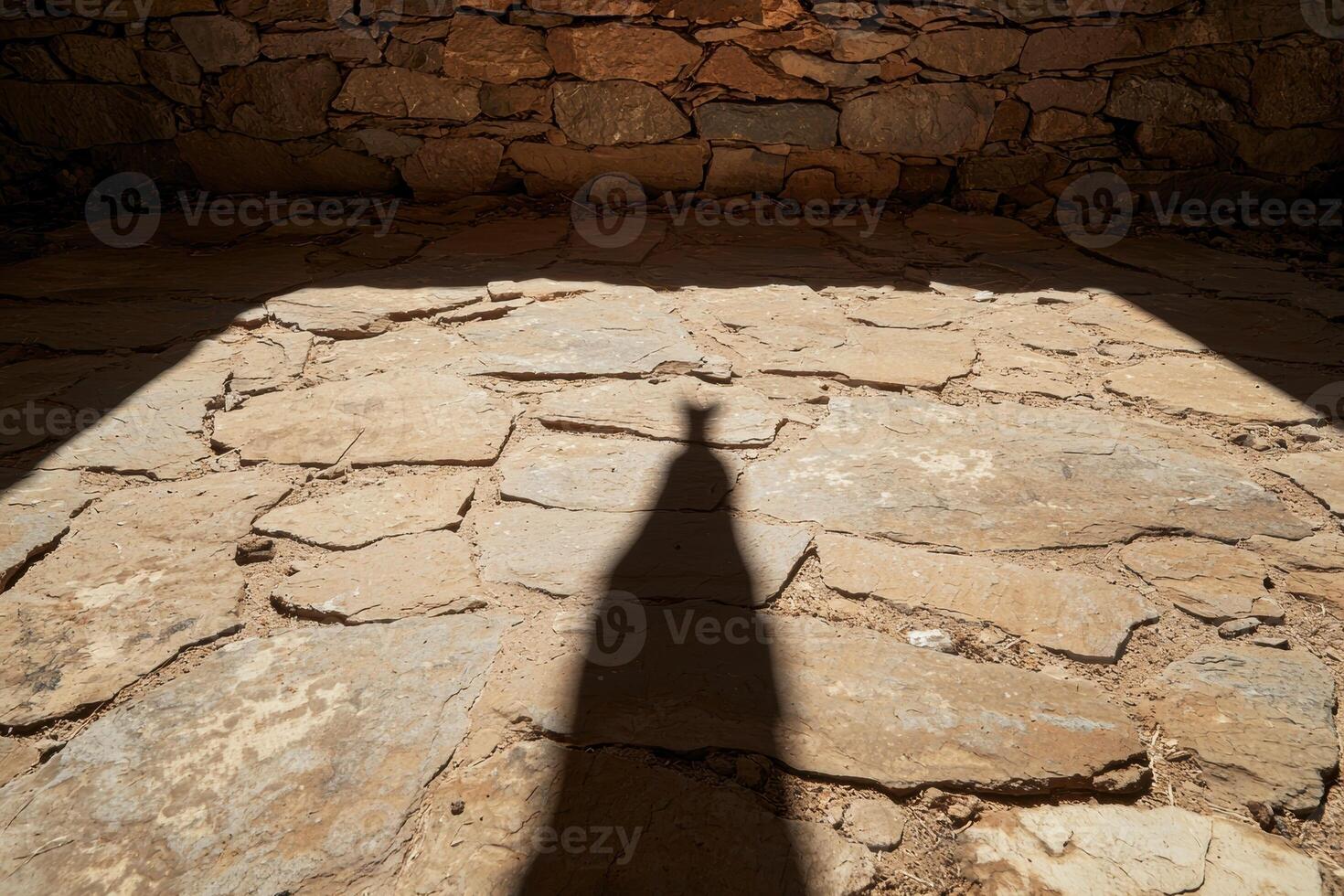 Shadow of a person on a stone floor in a building photo