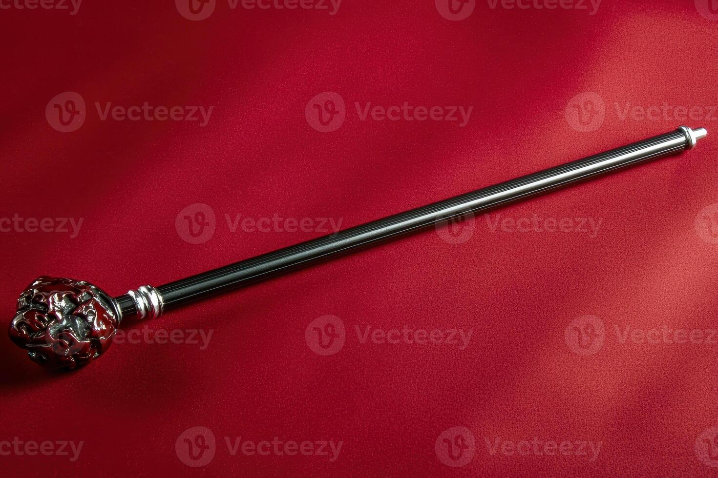 Ornate scepter on a red background photo