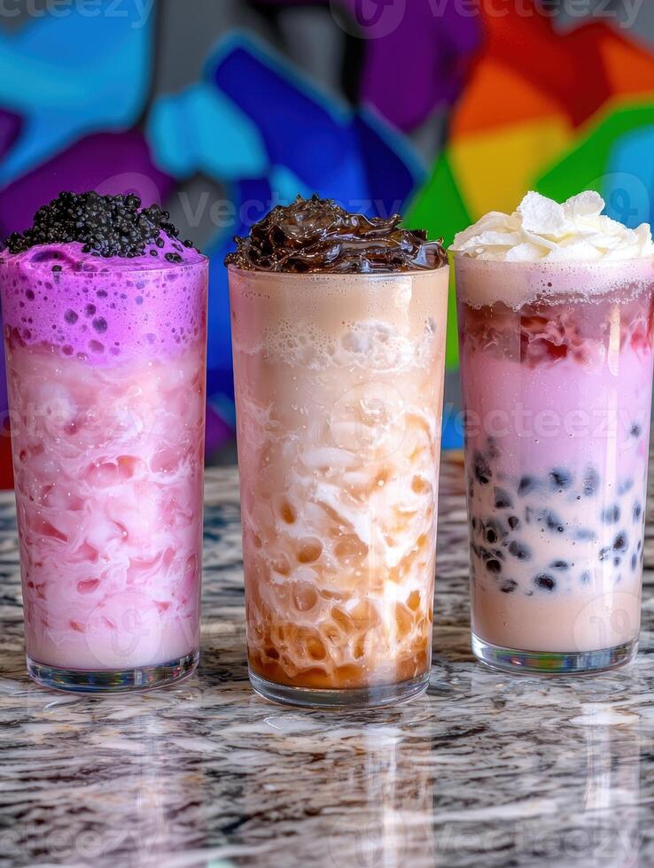 Three colorful bubble teas on a marble counter photo