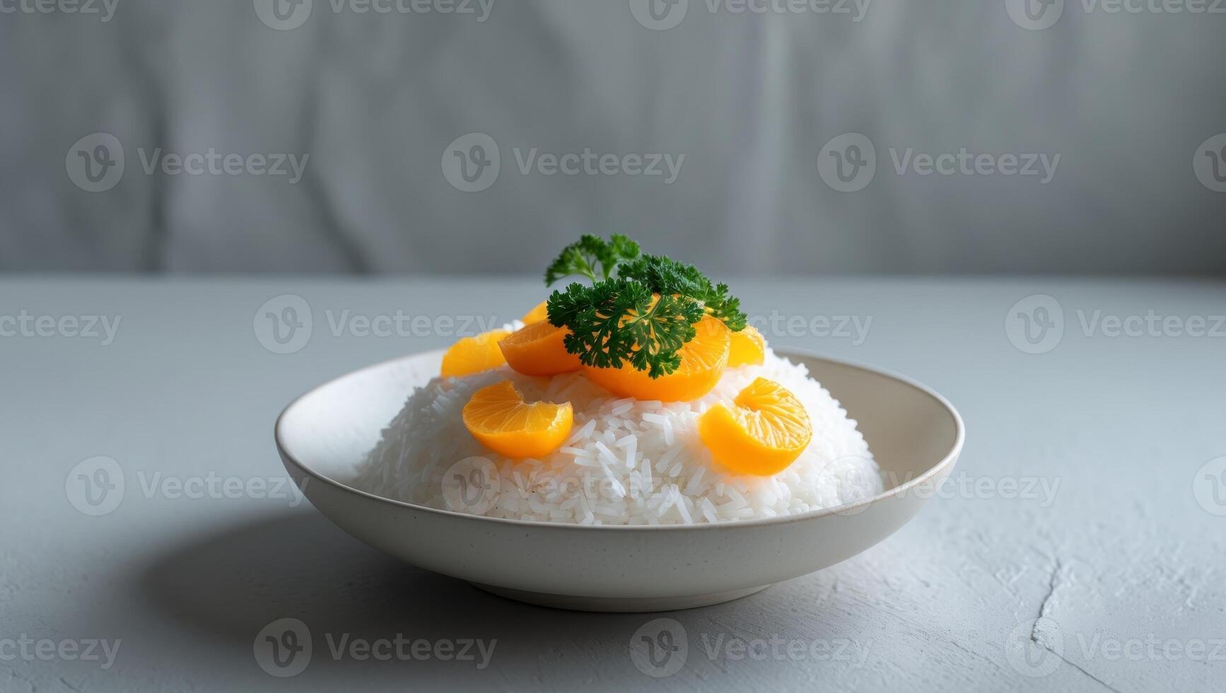 A bowl of rice with orange pieces and parsley on top. photo