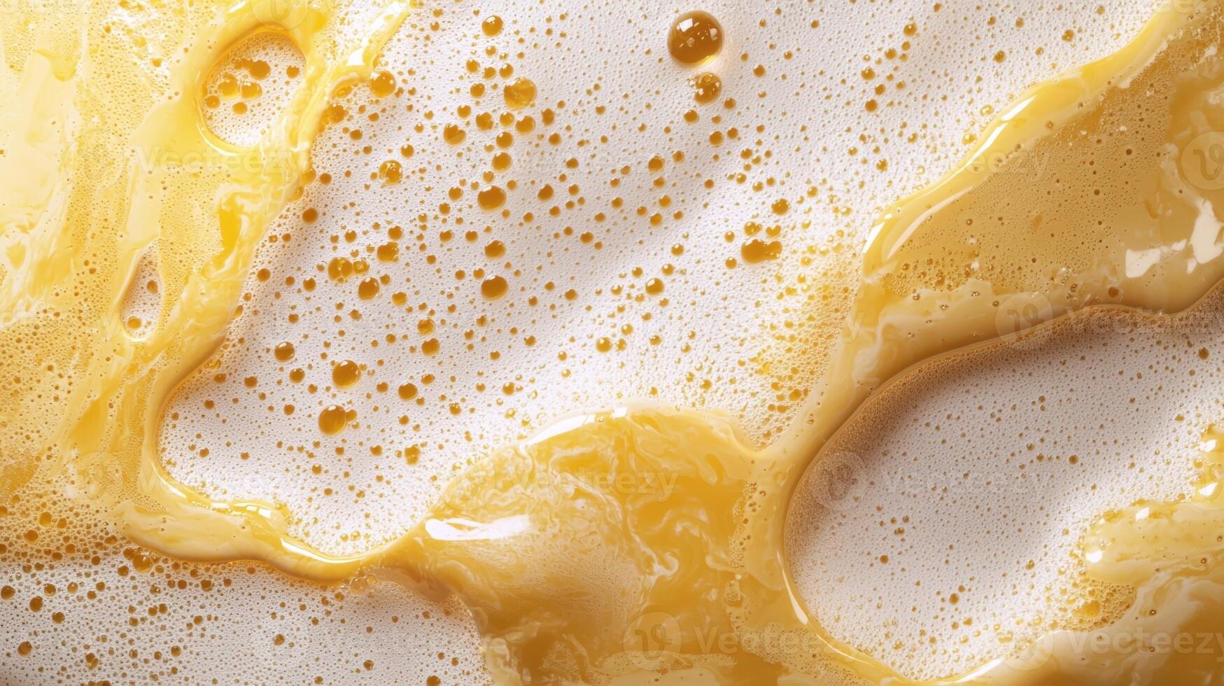Close up of frothy yellow liquid with bubbles photo