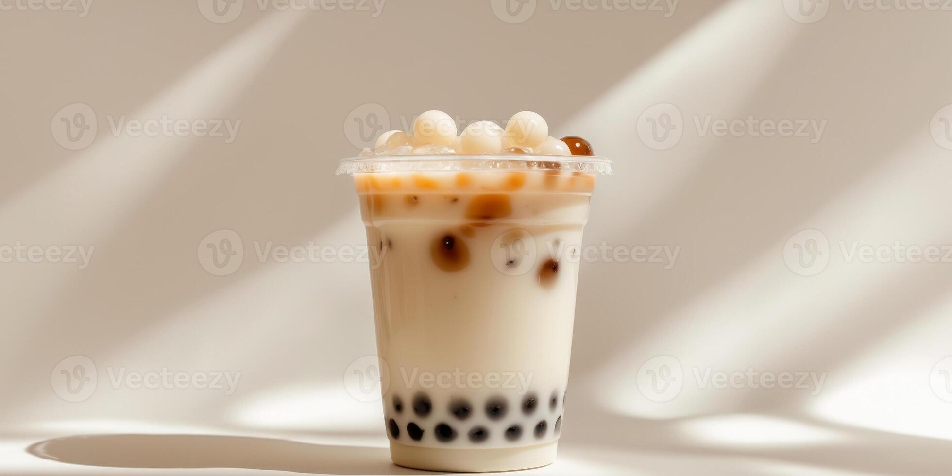 Iced Milk Tea with Tapioca Pearls in a Plastic Cup photo