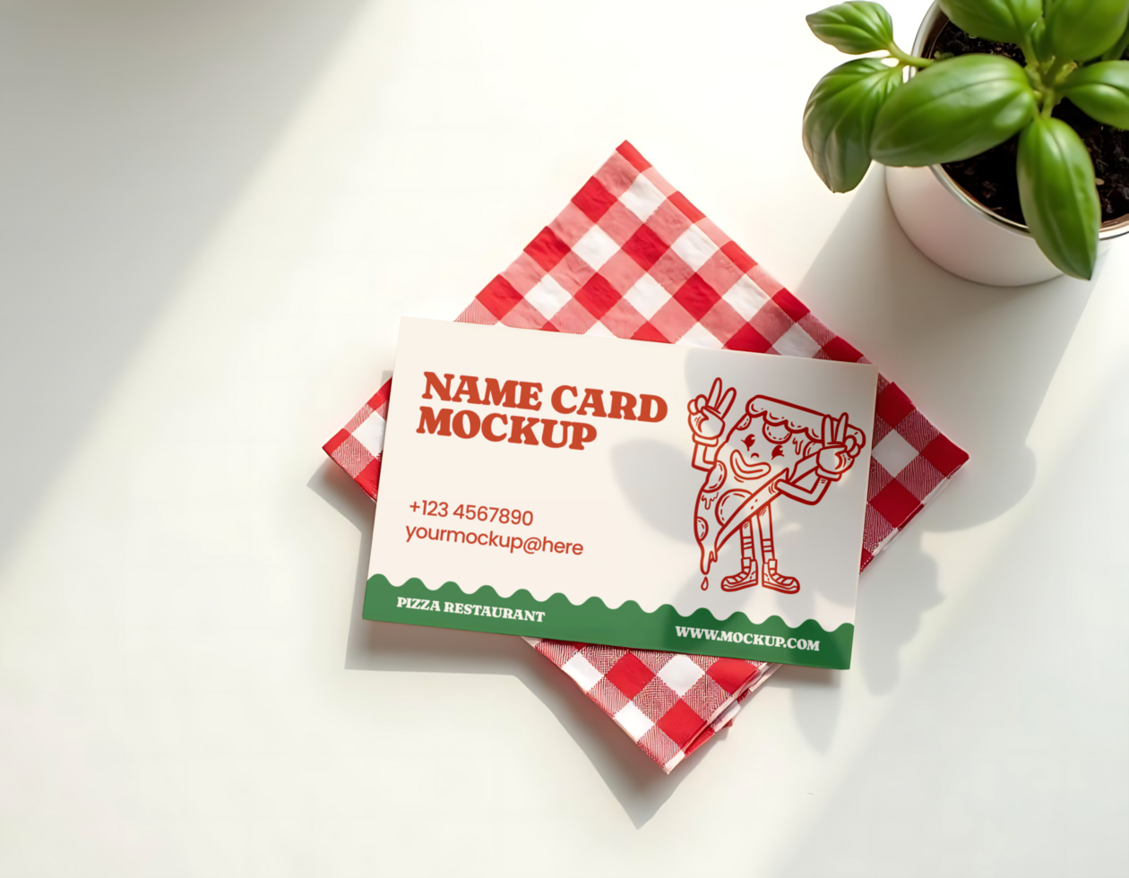 A pizza themed name card mockup rests on a red and white checkered napkin psd
