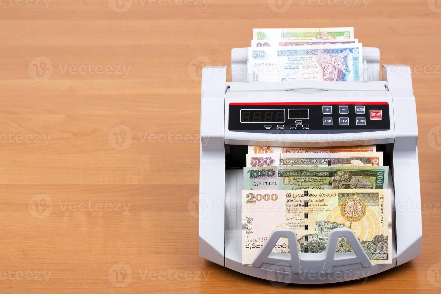 Sri Lankan money in the counting machine photo