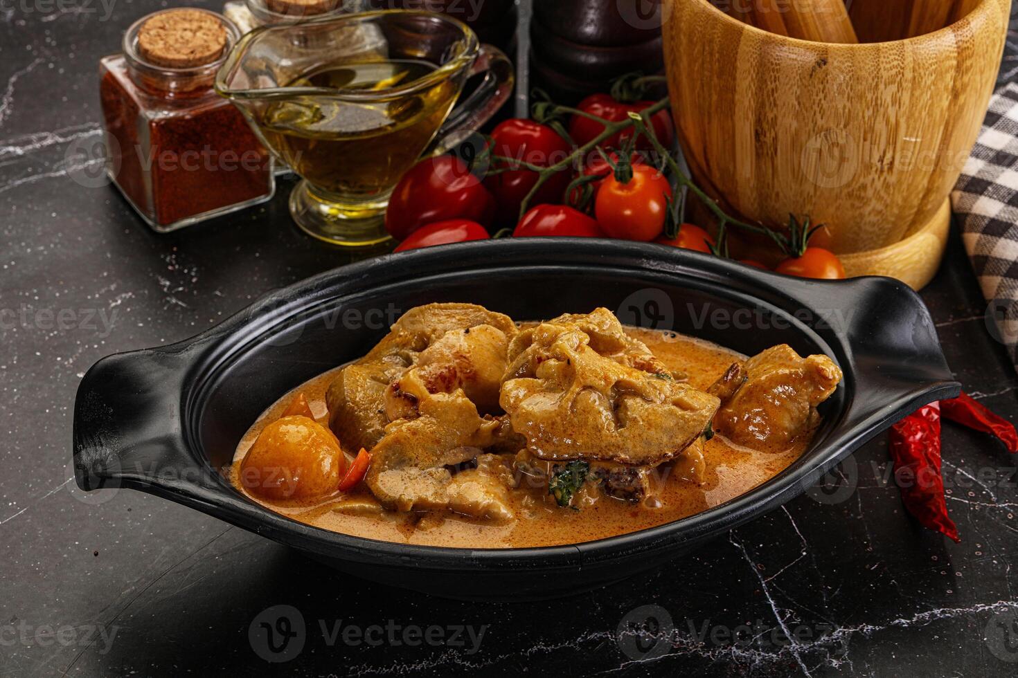 A bowl of food with meat and vegetables in it photo