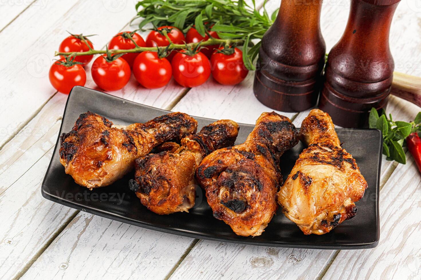 A plate with chicken wings and tomatoes photo