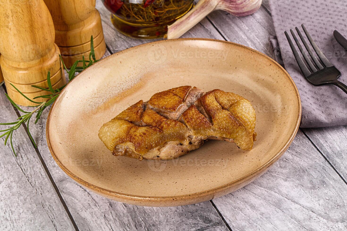 A plate of food on a table with a knife and fork photo