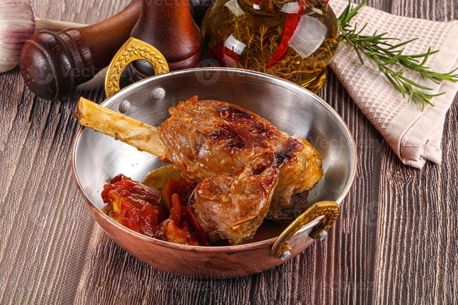 A bowl of food with a knife and a bottle of wine photo