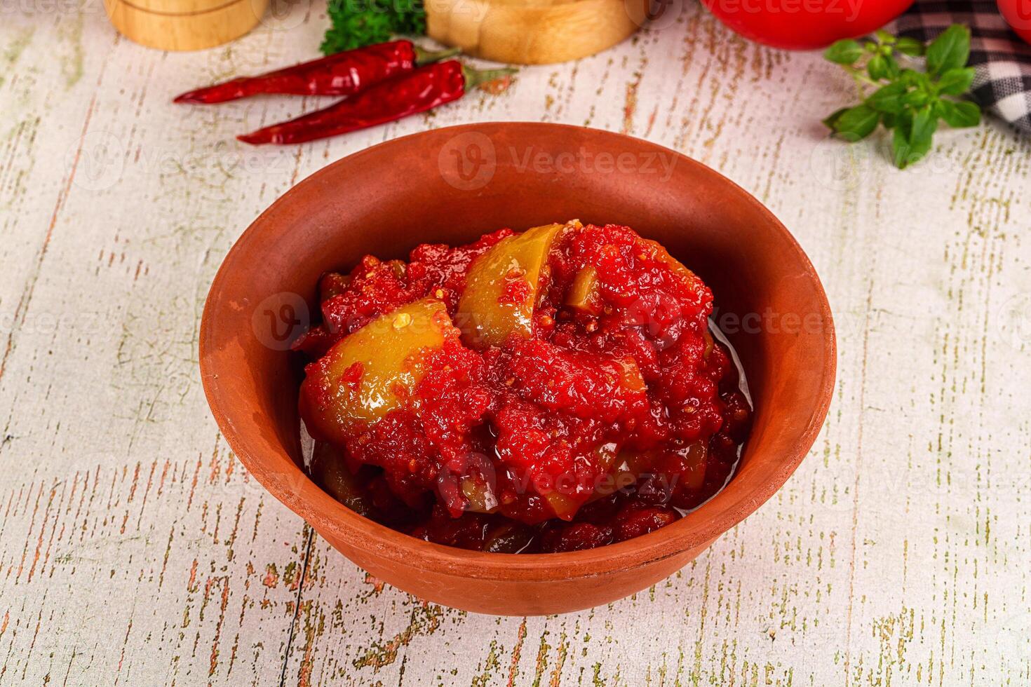 A bowl of tomato sauce with tomatoes and spices photo