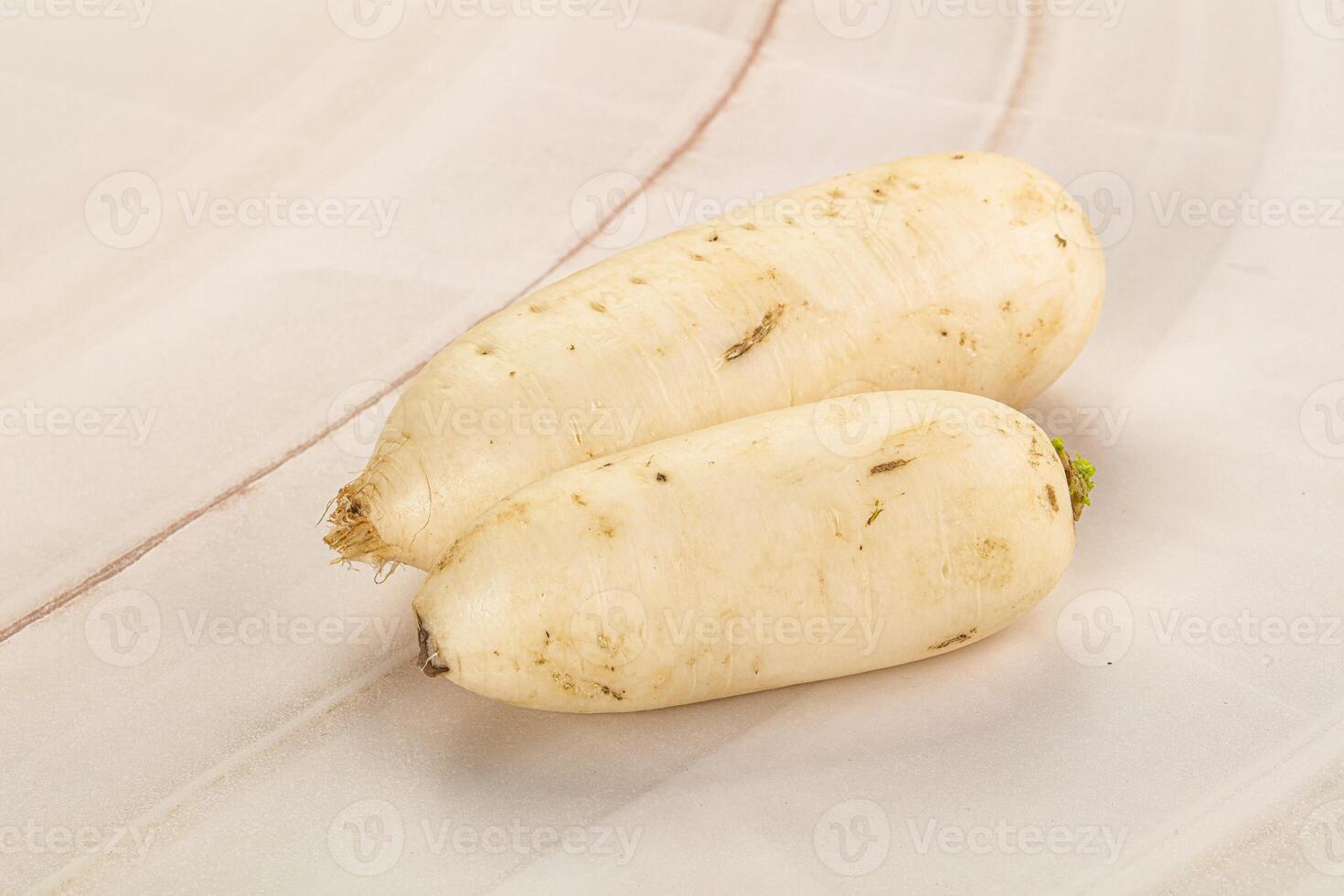 Two white radishes on a white background photo