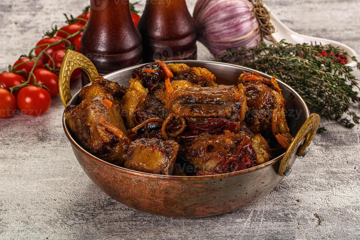A bowl of meat and vegetables on a table photo